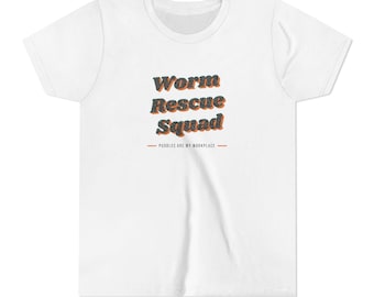 May include: A white short-sleeved t-shirt featuring the text "Worm Rescue Squad" in a dark, textured font with orange drop shadows. Below this, the text "PUDDLES ARE MY WORKPLACE" is printed in a smaller, simple font between two horizontal lines.