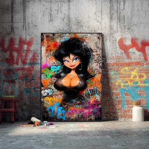 May include: A framed artwork featuring a cartoon woman with black hair, blue eyes, and red lips. The artwork is set against a backdrop of graffiti art with vibrant colors like orange, blue, and pink. The artwork is displayed against a brick and concrete wall.