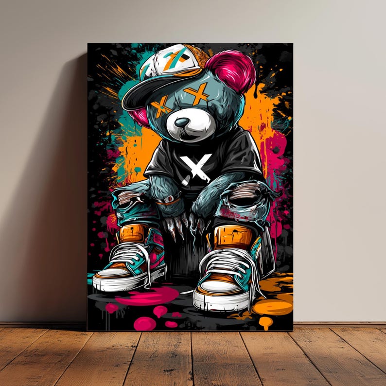 May include: A colorful pop art print of a teddy bear wearing a backwards baseball cap, black t-shirt with a white "X", and ripped jeans. The bear is sitting down and wearing sneakers. The background has paint splatters.