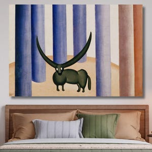 May include: A large canvas art print featuring a stylized, dark green creature with long, curved horns. The artwork is set against a backdrop of vertical blue, brown, and beige columns. The print is displayed above a bed with green bedding.