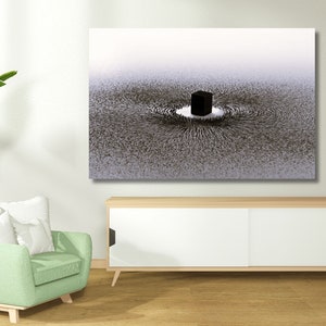 May include: A black and white abstract art print of a cube surrounded by a swirling pattern. The print is hanging on a white wall above a white cabinet with sliding doors.