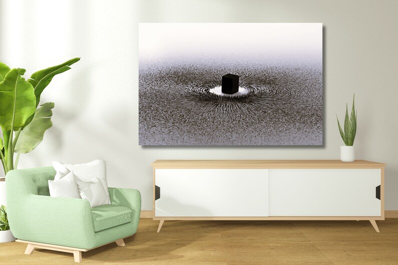 May include: A black and white abstract art print of a cube surrounded by a swirling pattern. The print is hanging on a white wall above a white cabinet with sliding doors.