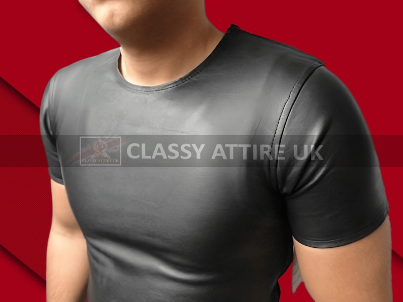 May include: Black short-sleeved t-shirt with a crew neck. The shirt is made of a smooth, shiny material. The text "CLASSY ATTIRE UK" is printed on the shirt.