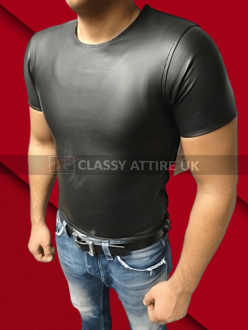 May include: Black short-sleeved t-shirt with a crew neck. The shirt is made of a shiny material and is paired with blue jeans and a black belt. The text "CLASSY ATTIRE UK" is visible.