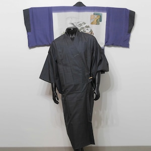 May include: A black kimono with a long, flowing design. The kimono is worn over a white shirt with a traditional Japanese pattern. The kimono is made of a soft, comfortable fabric.