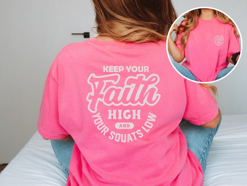 May include: Pink t-shirt with a white graphic that says "Keep Your Faith High and Your Squats Low".