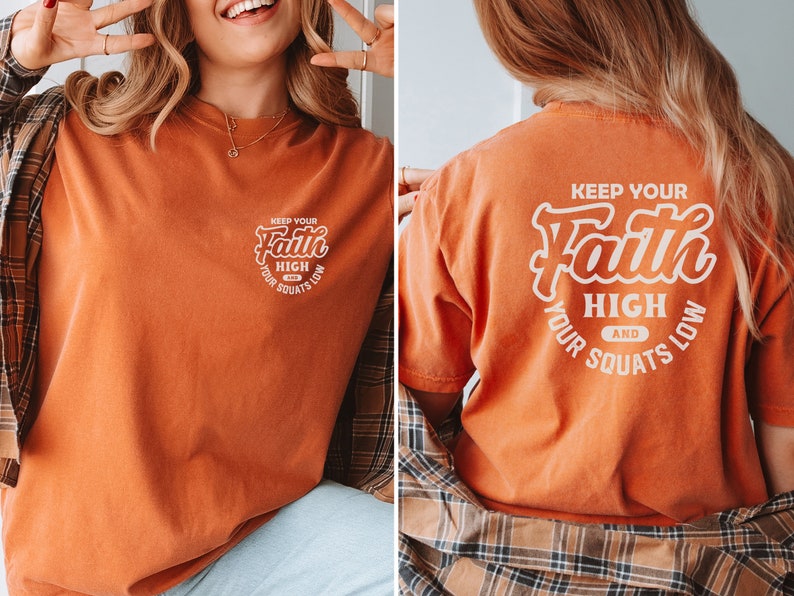 May include: Orange t-shirt with a white graphic that says "Keep your faith high and your squats low".