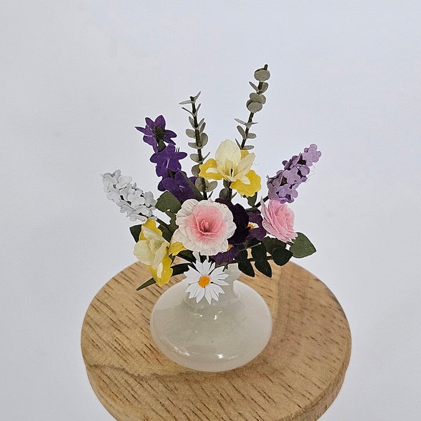 Summer handmade paper flowers in 12th scale. This flat backed arrangement in yellows, pink, white and mauve is in a white glass vase
