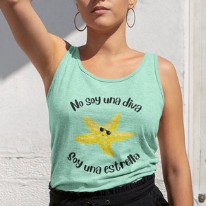 May include: A light green tank top with the text "No soy una diva, Soy una estrella" and a yellow starfish wearing sunglasses. The tank top is sleeveless and made of a soft material.
