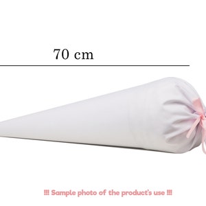 May include: A plain white cone-shaped fabric bag measuring 70 cm in length. The wide end of the cone is gathered and secured with a thin, light pink ribbon tied in a bow. The text 70 cm is visible above the cone, and the text !!! Sample photo of the product's use !!! is visible below.