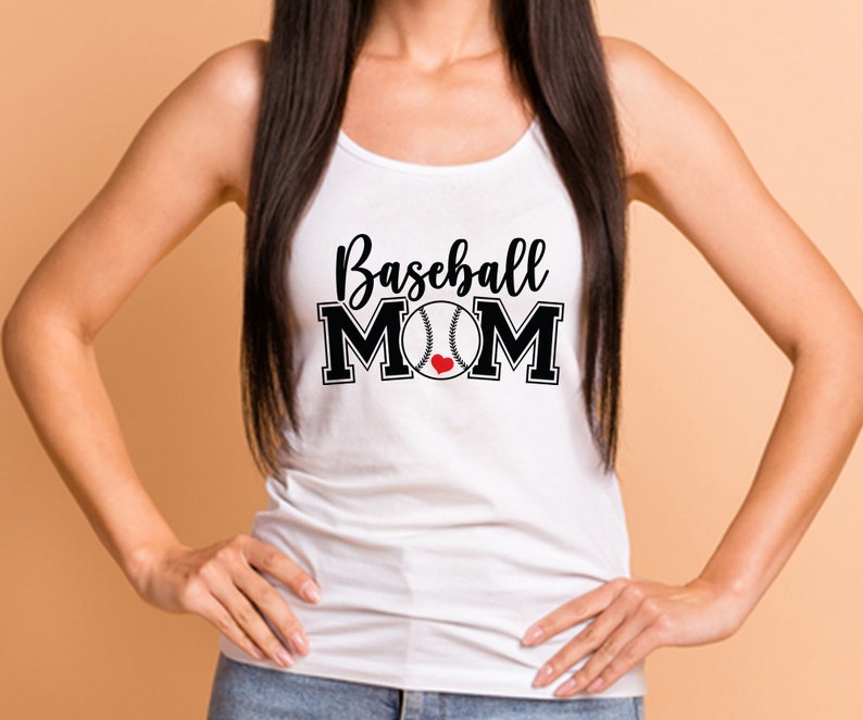 May include: White tank top with the words "Baseball MOM" in black script and block letters. A baseball graphic with a red heart replaces the "O" in MOM. The top is a casual style.