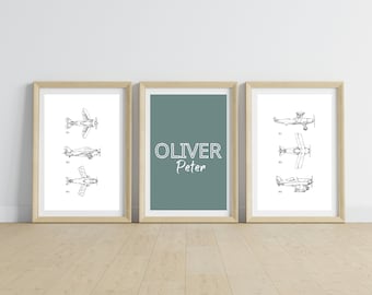May include: Three framed prints with a light blue background. The center print has the name "Oliver Peter" in white text. The other two prints feature black and white illustrations of vintage airplanes.