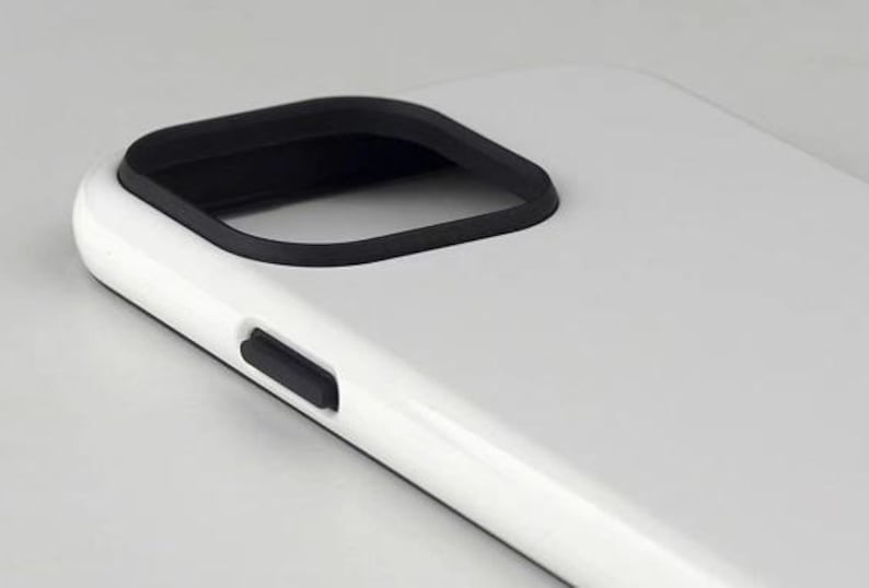 May include: A white phone case with a black camera cutout and a black side button. The case has a smooth, glossy finish and a minimalist design. The phone case is designed to protect the phone.