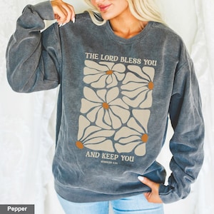 May include: A dark gray sweatshirt with a floral design and the text "The Lord Bless You and Keep You, Numbers 6:24".