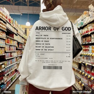 May include: White hooded sweatshirt with a black and white receipt design featuring the text "Armor of God" and a list of items from Ephesians 6:11-17. The receipt also includes the text "Put on the full armor of God, so that you can take your stand against the devil's schemes."