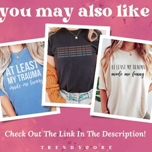 May include: Three t-shirts with the text "At least my trauma made me funny" in different colours. The shirts are blue, black, and white.