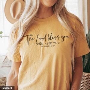 Könnte beinhalten: Senfgelbes T-Shirt mit dem Text "The Lord bless you and keep you Numbers 6:24" in Schwarz gedruckt.