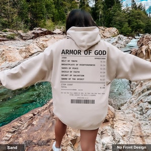 May include: A beige hoodie with a receipt-style graphic on the back that reads "Armor of God" and lists the "Armor of God" from Ephesians 6:11-17. The text at the bottom of the graphic reads "Put on the full armor of God, so that you can take your stand against the devil's schemes. Ephesians 6:11."