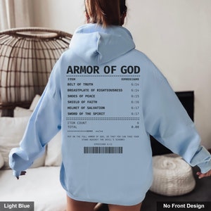 May include: Light blue hooded sweatshirt with a white print of a receipt listing the "Armor of God" with scripture references from Ephesians. The text reads "Put on the full armor of God, so that you can take your stand against the devil's schemes. Ephesians 6:11"