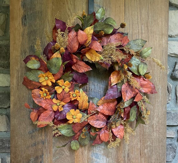 Fall salal wreath with yellow cosmos