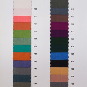 May include: Fabric swatches in a variety of colors, including white, pink, orange, green, blue, brown, and gray. The swatches are numbered 01 through 33. The text "QUALITY: JD" and "25/30 YARDS PER ROLE" is also visible. Mention shade number when ordering.