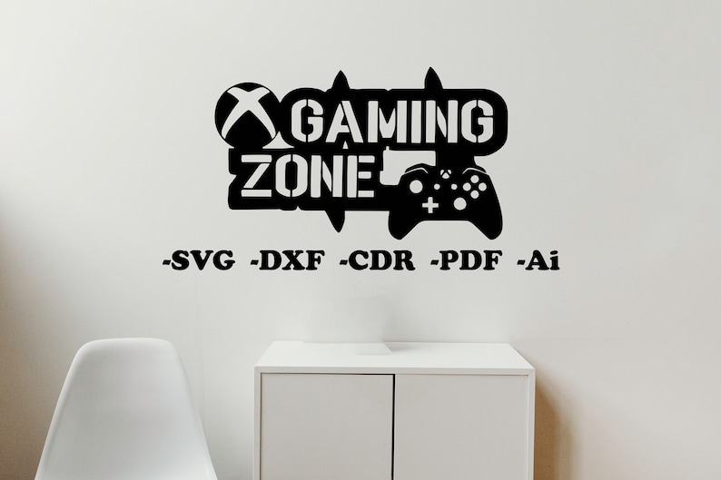 May include: Black and white graphic design of a video game controller with the text "Gaming Zone" and an Xbox logo. The design is on a white wall with a white chair and a white cabinet in the background.
