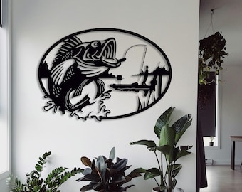 May include: Black metal wall art depicting a largemouth bass jumping out of the water with a fishing rod and line in the background.