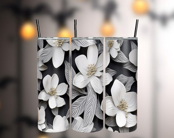 May include: Three stainless steel tumblers with a black background and white paper flower design. The flowers have a 3D effect and are layered on top of each other.