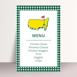 May include: A menu card with a green and white checkered border. The top of the card features a yellow outline of the United States with a red flag. The word "MENU" is printed below the graphic, followed by a list of food items.