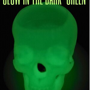 May include: A green glow-in-the-dark skull. The skull is made of a soft, pliable material and is perfect for Halloween decorations or as a fun party favor.