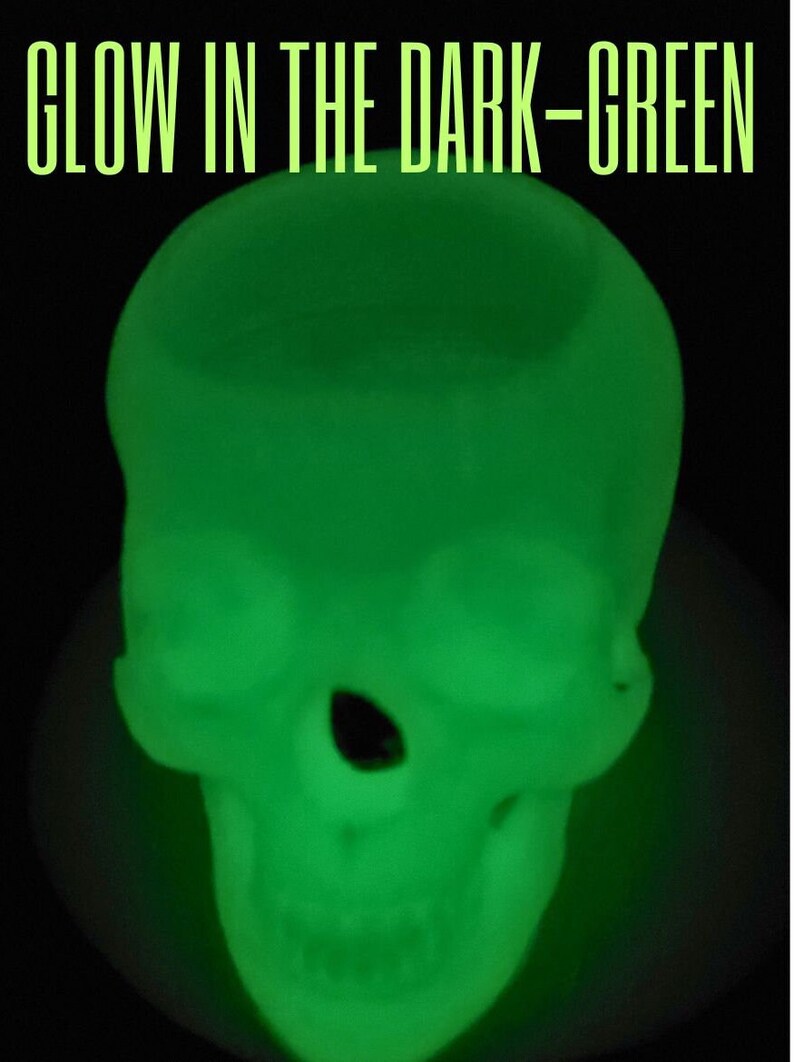 May include: A green glow-in-the-dark skull. The skull is made of a soft, pliable material and is perfect for Halloween decorations or as a fun party favor.