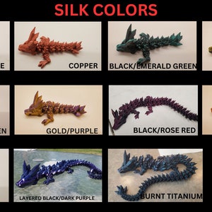 May include: A collection of 12 small, 3D printed dragon figurines in various colors, including bronze, copper, black, emerald green, dark gold, blue, green, gold, purple, rose red, magenta, and titanium. The dragons are all in the same pose, with their heads tilted up and their wings spread out.