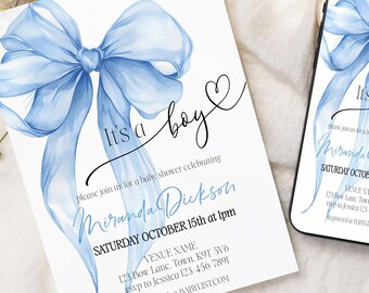 May include: A baby shower invitation and a smartphone display the text "It's a boy" with a watercolor blue bow design. The invitation includes event details. The items rest on a white fabric surface with floral and ribbon accents.