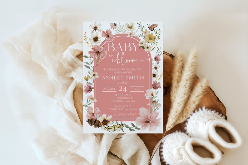 May include: A pink and white baby shower invitation with floral illustrations and butterflies. The text reads "Baby in Bloom" and includes the name "Ashley Smith" and the date "August 24".