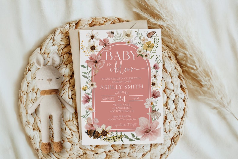 beautiful boho pink with white writing surrounded by stunning wildflowers and butterflies