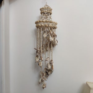 Wind chimes with shells in the style of macrame marine style in the decor of the apartment gentle sound