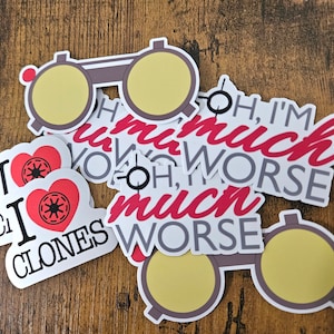 May include: A set of stickers featuring a heart with the text "I love Clones" and a pair of glasses with the text "Oh, I'm much worse" in red and gray lettering.