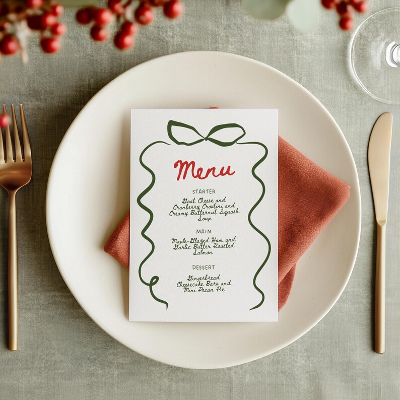 May include: A white menu card with a green ribbon design and the word "Menu" in red. The menu lists starters, main courses, and desserts, including Goat Cheese and Cranberry Crostini, and Maple Glazed Ham.