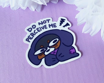 May include: A sticker featuring a cartoon dog wearing a purple hooded cloak. The dog has a worried expression and the text "DO NOT PERCEIVE ME" is written above it.