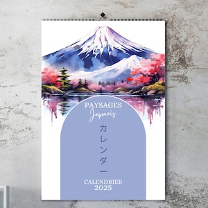 May include: A watercolor painting of Mount Fuji with cherry blossoms in the foreground. The text "Paysages Japonais" and "Calendrier 2025" is printed below the image. The text "カレンダー" is also printed in Japanese.