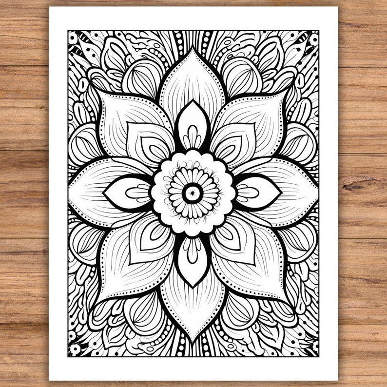 May include: Black and white floral mandala design on a white background. The intricate pattern features a central flower with detailed petals and surrounding ornamental elements. The artwork is suitable for coloring or decorative purposes.