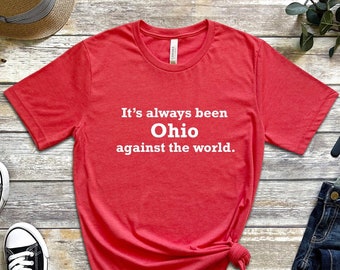 May include: Red t-shirt with white text that reads "It's always been Ohio against the world."