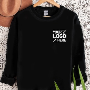 May include: Black sweatshirt with a white graphic that says "YOUR LOGO HERE" on the front.