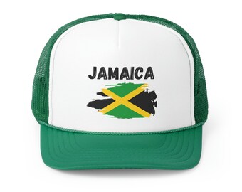 May include: A white trucker hat with a green mesh back. The front of the hat features a black and white distressed graphic of the Jamaican flag with the word "JAMAICA" in black text above the flag.
