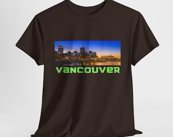 May include: A brown t-shirt with a cityscape image of Vancouver, British Columbia at night. The text "VANCOUVER" is printed in green and blue letters below the image.