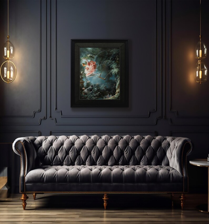 May include: A dark gray tufted sofa with wooden legs in a room with dark gray walls and a framed painting of a woman in a pink dress flying through a forest.