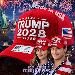 May include: A red baseball cap with the text "TRUMP 2028" in white, along with the American flag. The hat has "Made in USA" printed on it. The image also shows two people wearing the same hat.