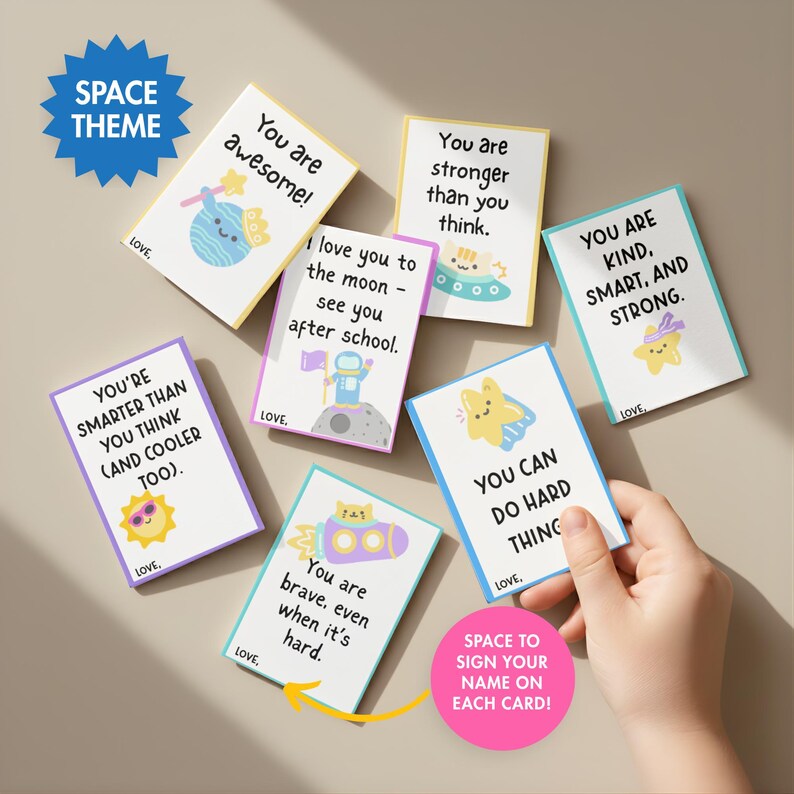 May include: A collection of colorful space-themed cards with encouraging messages like "You are awesome!" and "You are brave, even when it's hard." Each card features cute illustrations of planets, stars, and rockets. The cards are designed to be signed.