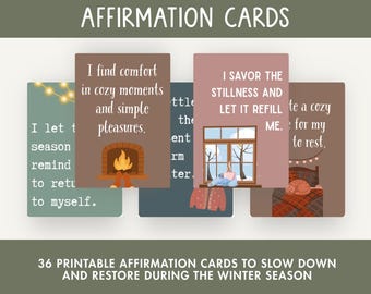 May include: A collection of printable affirmation cards with a cozy winter theme. The cards feature illustrations of a fireplace, a window with a cup of tea, and a bed with a cat. The text on the cards includes phrases like "I find comfort" and "I savor the stillness."