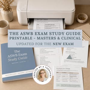 May include: A printed ASWB Exam Study Guide for Masters and Clinical levels, featuring a blue cover and multiple white pages with text, tables, and diagrams. A circular sticker shows a person with glasses and the text CREATED BY A THERAPIST.